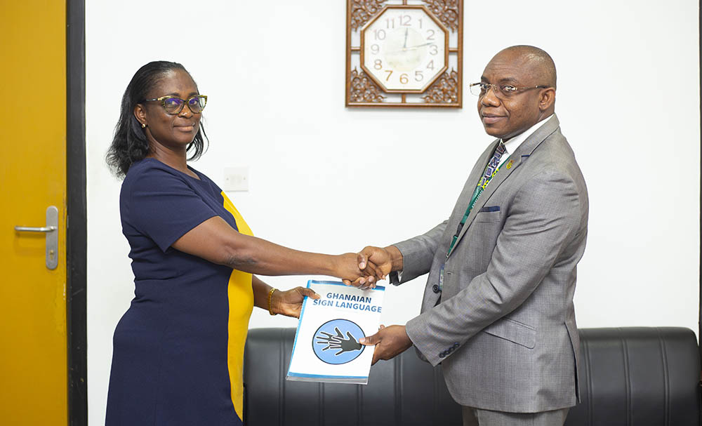 Prof Agyare presents books to Ms. Seneadza